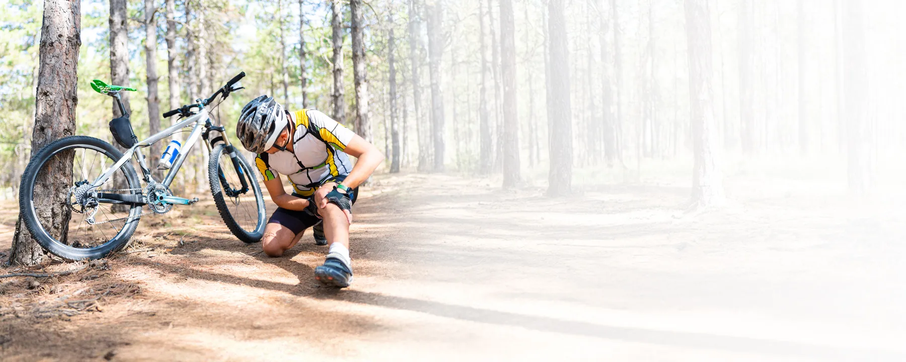 cyclist holding knee