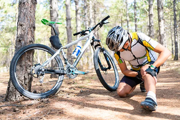 cyclist holding knee