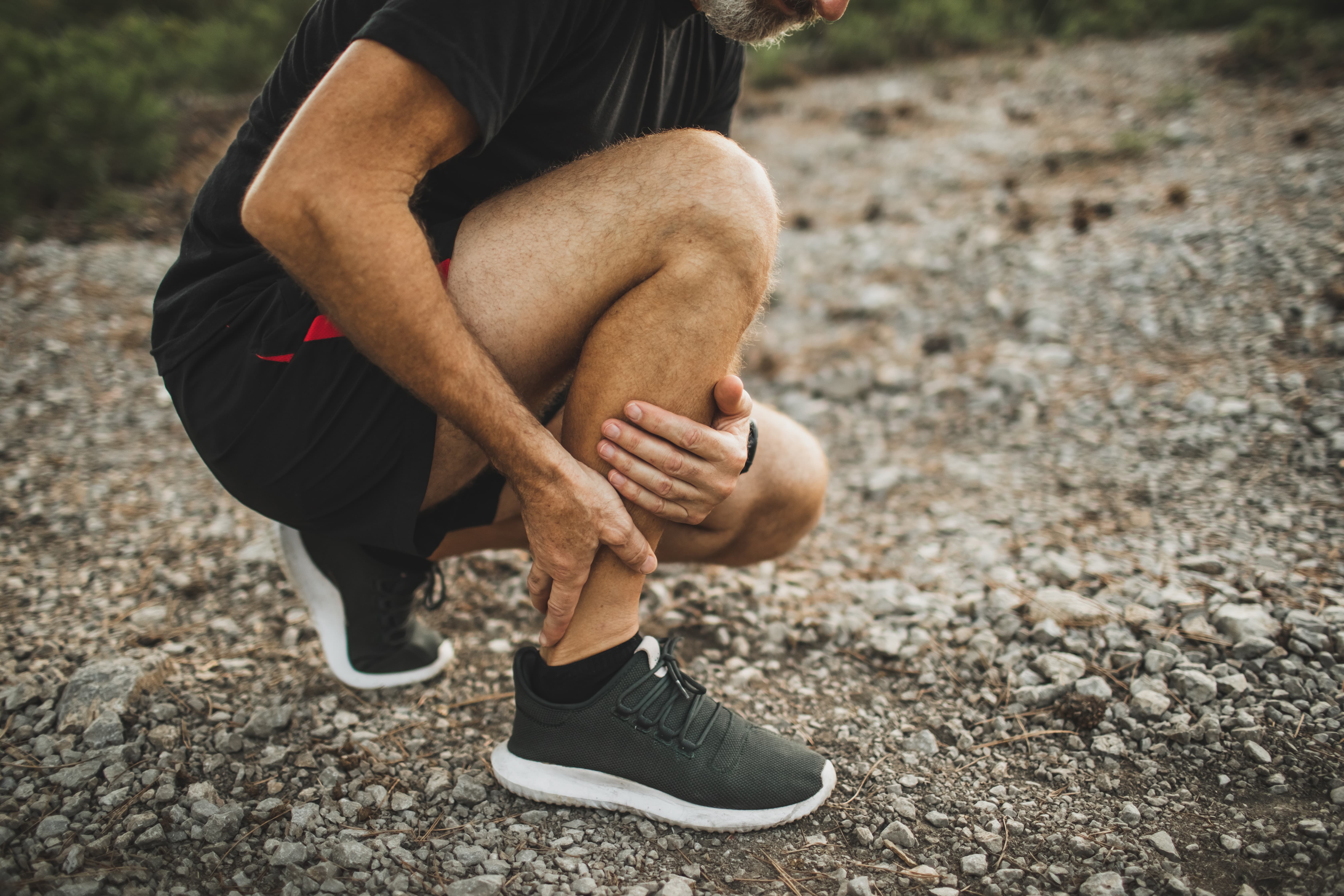 Man holding painful shin