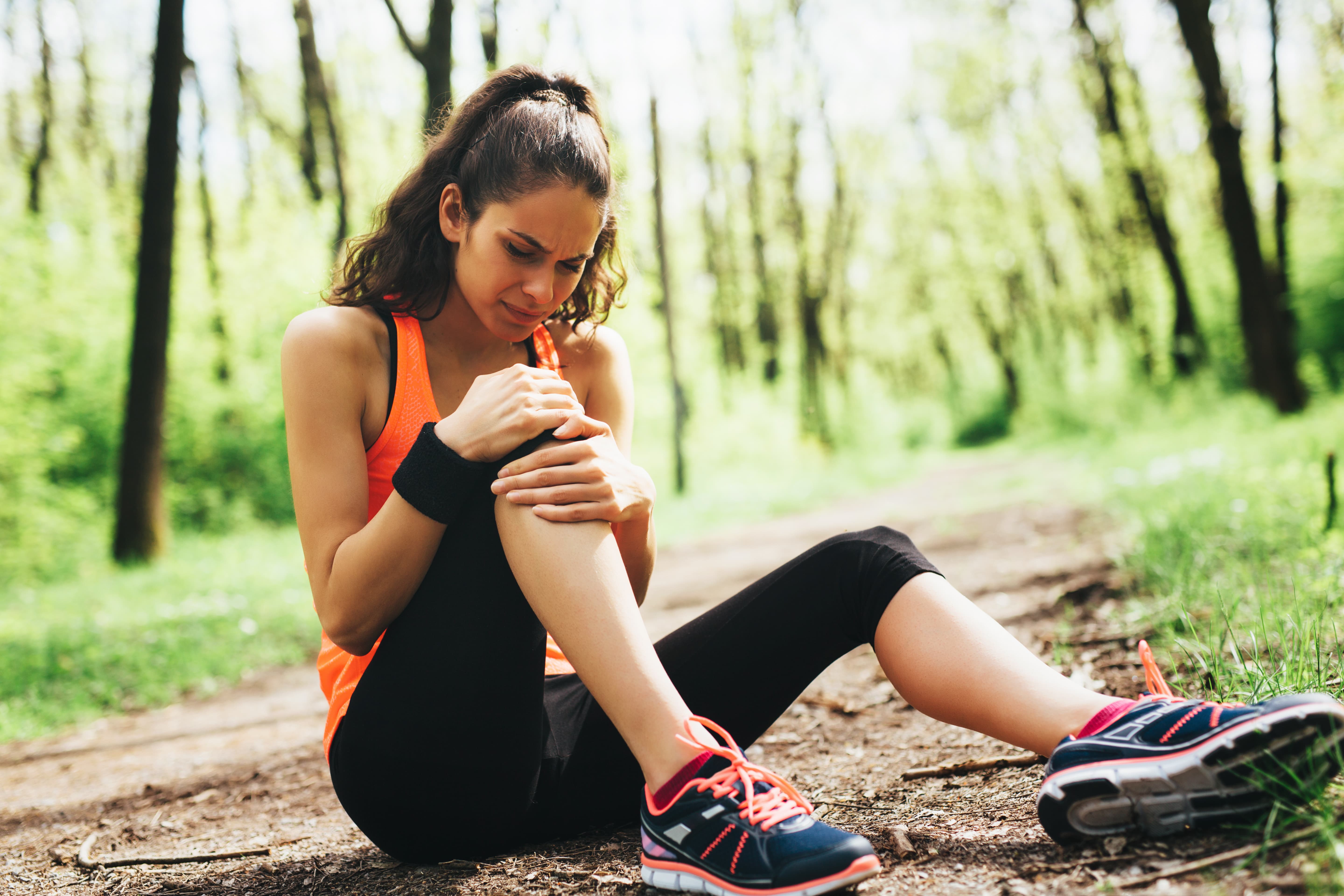 Woman holding painful knee